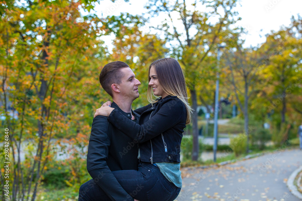 Young couple in love walking in the autumn park Young couple in love walking in the autumn park