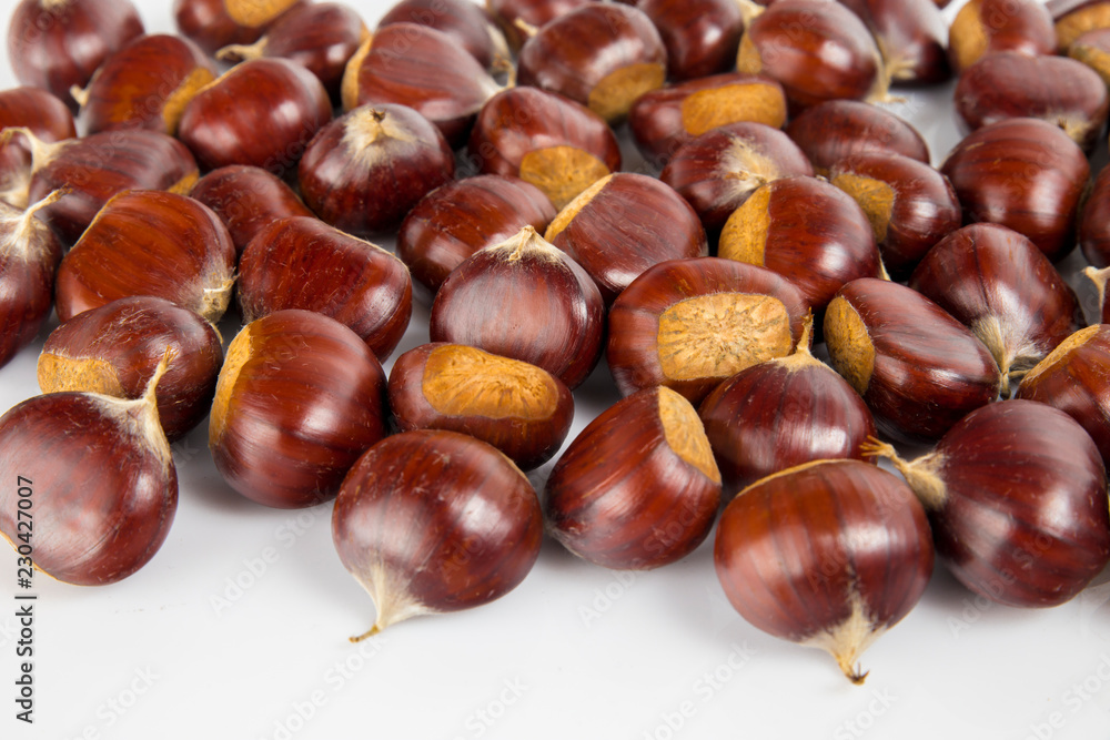 Fresh chestnuts with peeled roasted chestnut isolated on white background. Hippocastanum isolated. Fresh chestnuts with peeled roasted chestnut isolated on white background. Hippocastanum isolated.