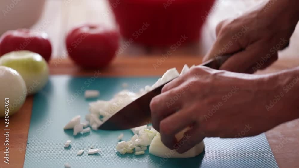 Food preparing, chopping onions using sharp kitchen knife. Steadicam Close-up, unrecognizable person Food preparing, chopping onions using sharp kitchen knife. Steadicam Close-up, unrecognizable person