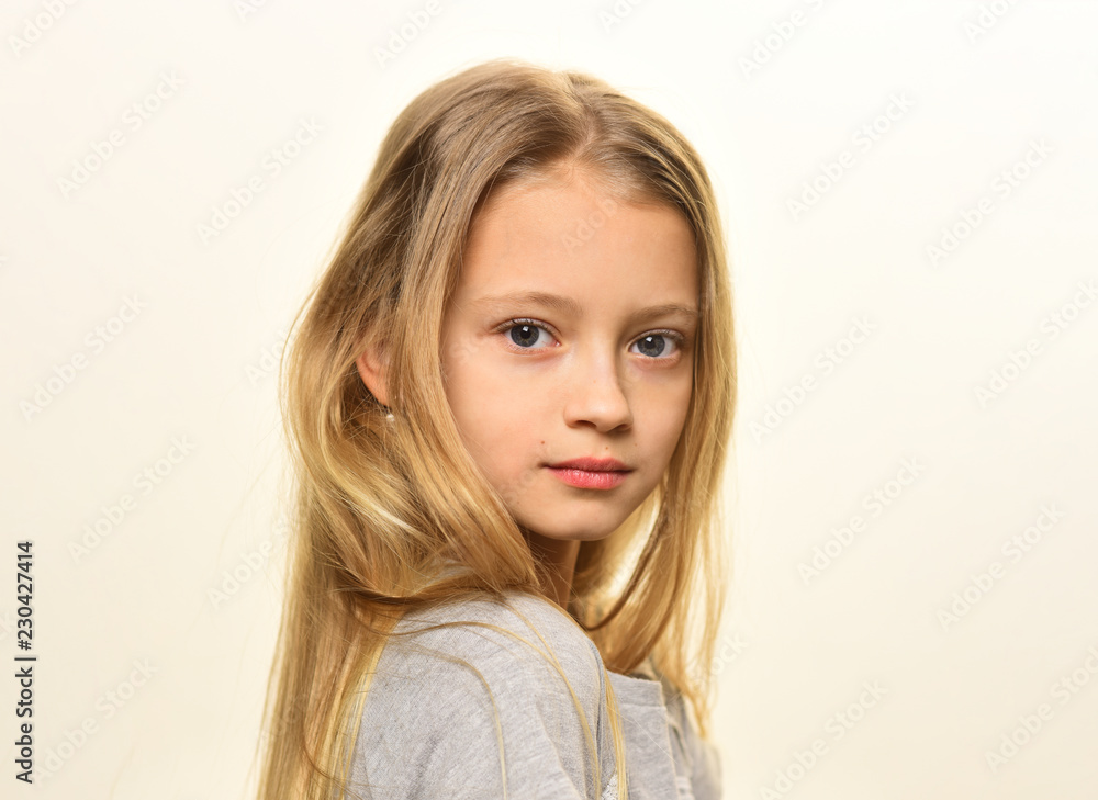 Fototapeta premium small blonde. small blonde girl isolated on white. small girl with long blonde hair. small blonde with pretty face. perfect girl.
