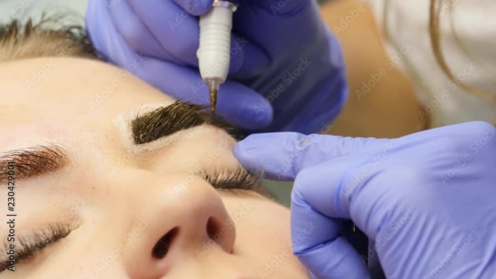 close-up hands of the master doing brows tattoo. professional eyebrow permanent makeup. 4K close-up hands of the master doing brows tattoo. professional eyebrow permanent makeup. 4K