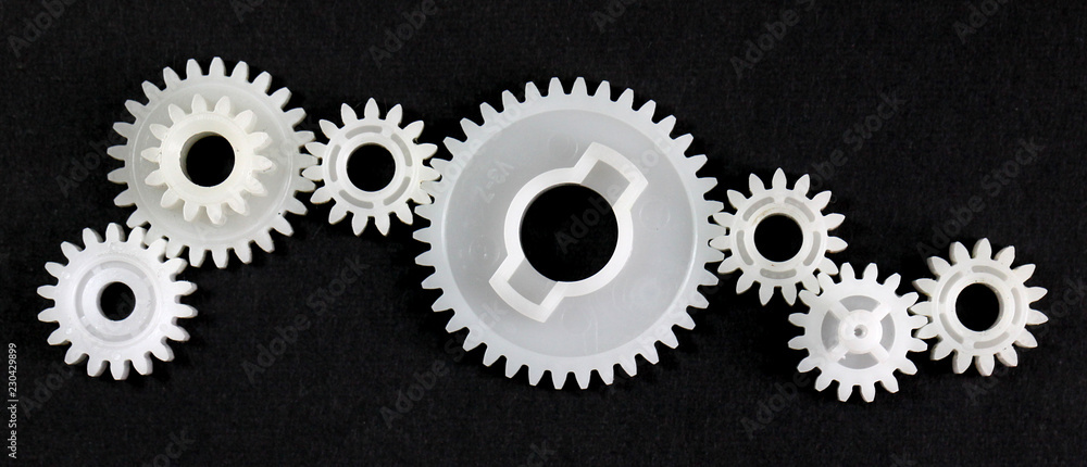 Several gears that are in connection with each other on black background Several gears that are in connection with each other on black background