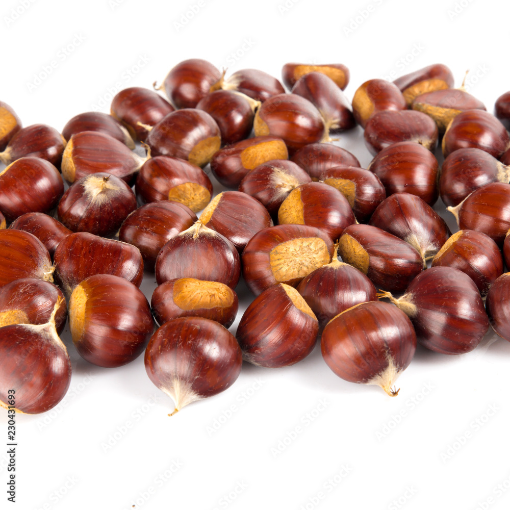 Fototapeta premium Fresh chestnuts with peeled roasted chestnut isolated on white background. Hippocastanum isolated.