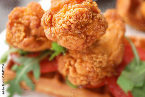 Delicious chicken with waffle, closeup