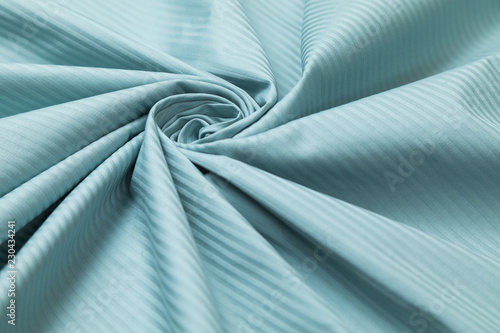 Photos Blue jacquard with development in a thin strip is decoratively laid in to spiral