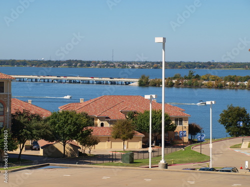 The Interstate 30 Causeway Bridge over Lake Ray Hubbard Recreational Area. The red tile roofs are counterpoint to the blue sky and water.