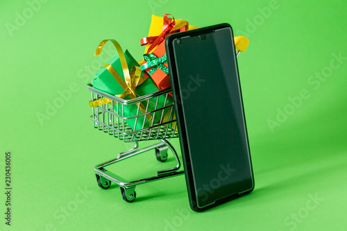 Online shopping concept - trolley cart full of presents. Black Friday and Ciber Mondey photo