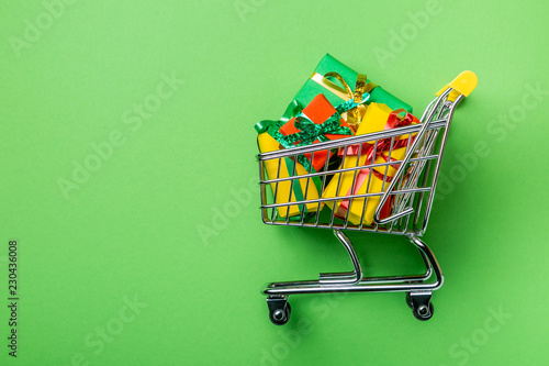 Online shopping concept - trolley cart full of presents. Black Friday and Ciber Mondey