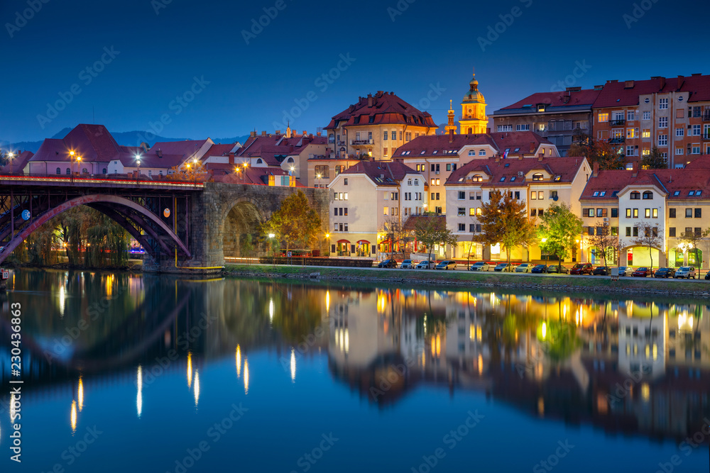 Maribor, Slovenia. Cityscape image of Maribor, Slovenia during autumn twilight blue hour with reflection of the city in Drava River.