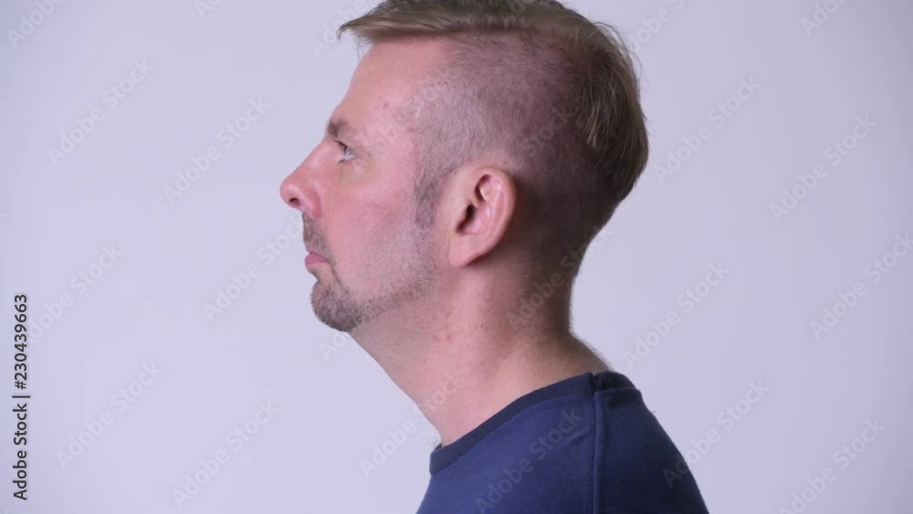 Head shot profile view of blonde man looking up Head shot profile view of blonde man looking up