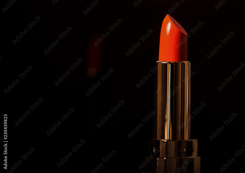 Women's lipstick red. On a black background Women's lipstick red. On a black background