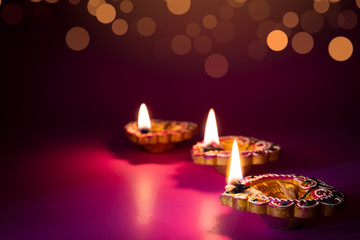 Happy Diwali - Clay Diya lamps lit during Dipavali, Hindu festival of lights celebration