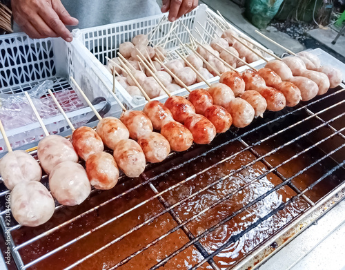 Thai grilled sausauge on stove at local market Thailand,snack meal photo