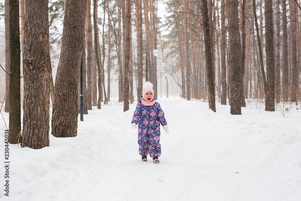 Childhood and children concept - baby girl walk in the winter outdoors Childhood and children concept - baby girl walk in the winter outdoors