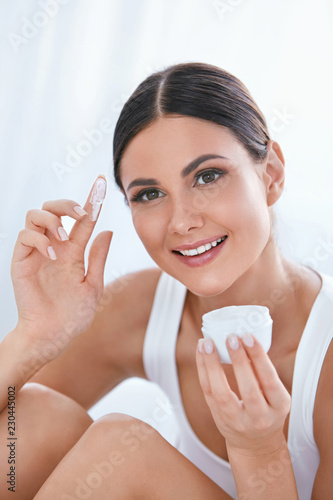 Beauty Face Skin Care Cream. Girl With Facial Cream On Finger