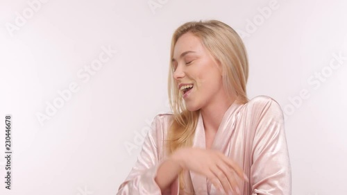 beauty happy smiling funny nordic model in bathrobe with ideal skin in studio photo