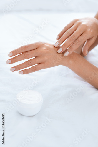 Woman Hand With Cream. Closeup Of Applying Hand Lotion On Hands © puhhha
