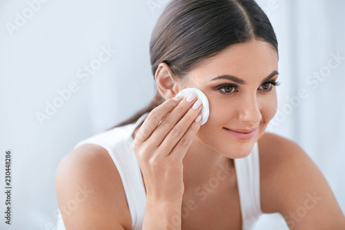 Face Skin Care. Beautiful Woman Removing Makeup With Cotton Pad