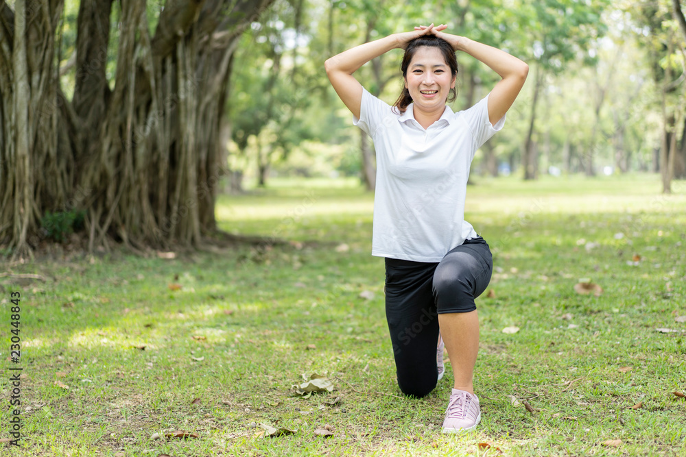 young asian woman jogging or exercise in green park .sporty woman concept.