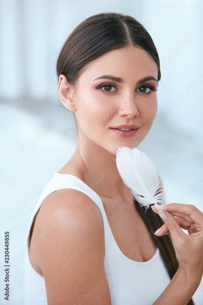 Beauty Skin Care. Woman Touching Soft Face Skin With Feather Beauty Skin Care. Woman Touching Soft Face Skin With Feather