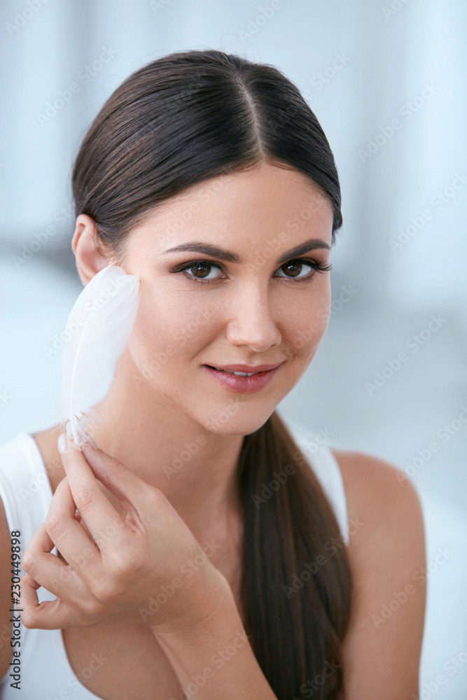 Beauty Skin Care. Woman Touching Soft Face Skin With Feather Beauty Skin Care. Woman Touching Soft Face Skin With Feather