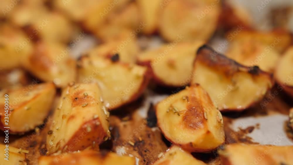 Roasted Potatoes with Rosemary, Garlic, Pepper and Thyme in the Oven. Healthy Vegan Diet or Cooking Recipe Concept 4K Macro Closeup Footage Roasted Potatoes with Rosemary, Garlic, Pepper and Thyme in the Oven. Healthy Vegan Diet or Cooking Recipe Concept 4K Macro Closeup Footage