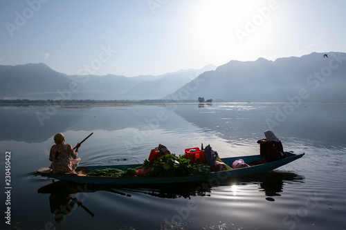 Women with vegetables on boat at Dal lake, Kashmir, India photo