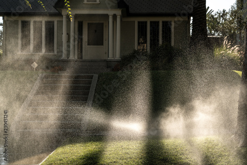 Sprinklers in front lawn of California home