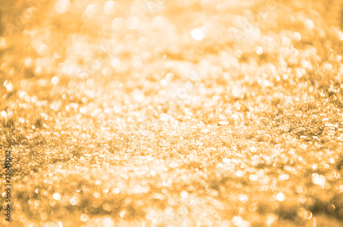 Yellow golden abstract glittering background.Selective focus.