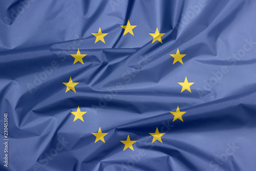 Fabric flag of Europe. Crease of European Flag background, A circle of twelve five-pointed yellow stars on a blue field.