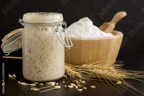 Active rye sourdough in a glass jar for homemade bread.