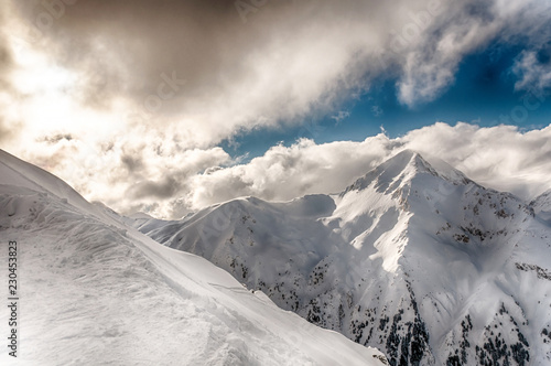 Winter Alpine snowpeak background with ountainous terrain and snow covered trees texture. Bansko, Bulgaria photo