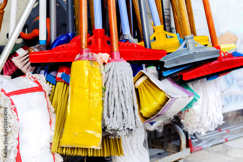 Cleaning products on display in the street - mops, brooms, brushes