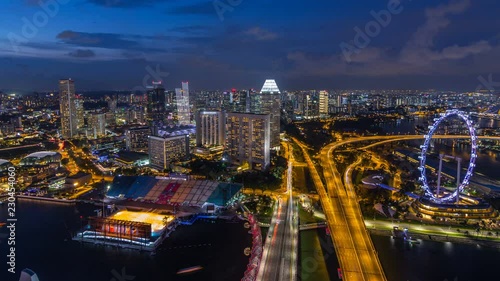 Wallpaper Mural Skyline of Singapore with famous Singapore Ferries Wheel day to night timelapse at twilight Torontodigital.ca