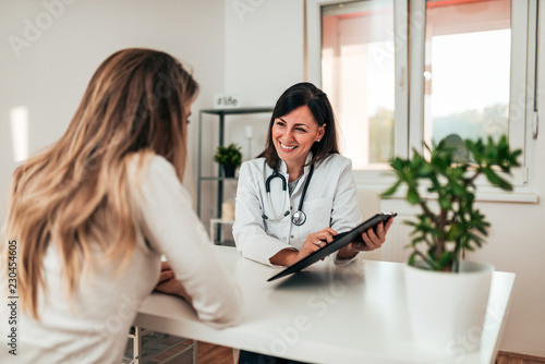 Female doctor explaining diagnosis to her young patient.