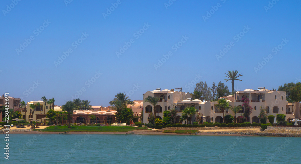 Beautiful view of the coastline with houses and hotels on the red sea. Tourist region in Egypt. Hurghada and its traditions. Stock photo for design