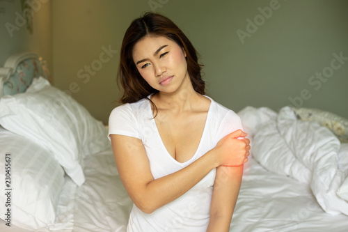 Asian Woman have a Upper arm pain,Healthcare Concept © 220 Selfmade studio