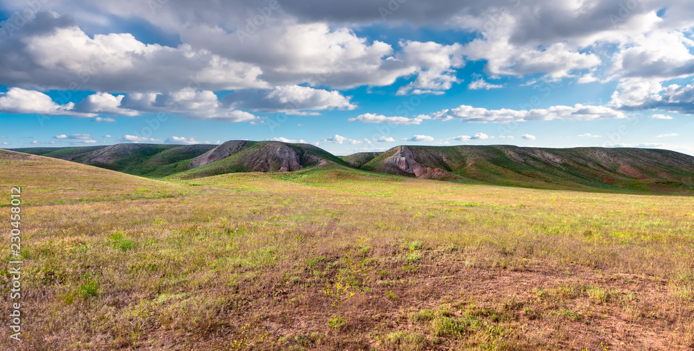 panorama hills in sunny day. Vista scenic idylic landscape hills sun through the clouds meadow