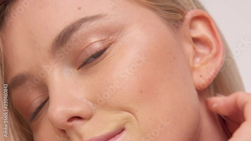 closeup portrait of nordic woman with ideal skin put off hair back of the ear photo