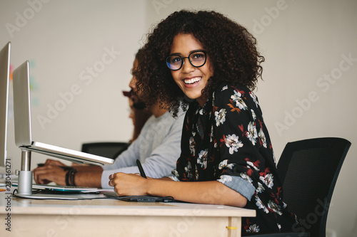 Smiling businesswoman working in office