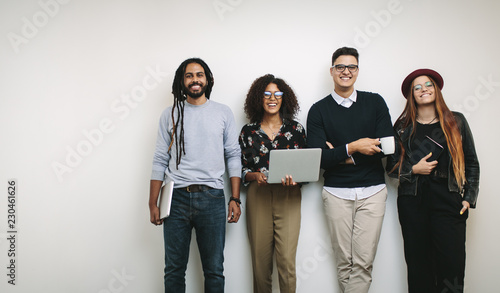 Konstfotografi Businessman holding a coffee cup standing with coworkers in offi