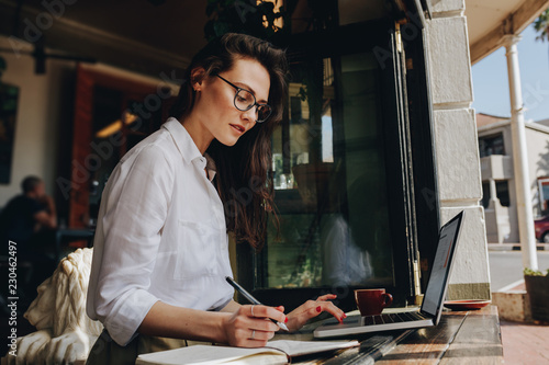 Businesswoman working from a coffee shop photo