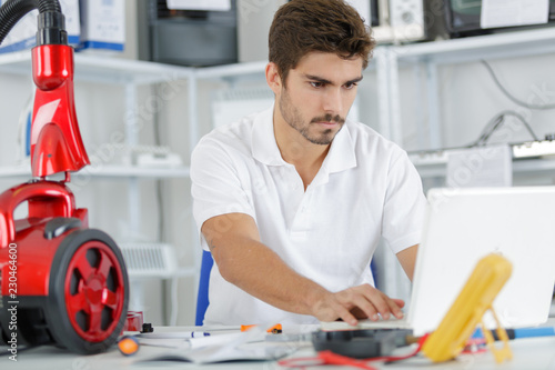 handsome engineer researching manufacturing issues with vacuum cleaner