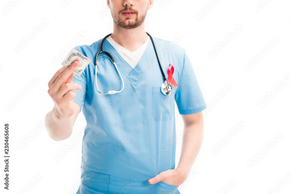 cropped image of doctor with red ribbon on uniform showing condom isolated on white, world aids day concept cropped image of doctor with red ribbon on uniform showing condom isolated on white, world aids day concept