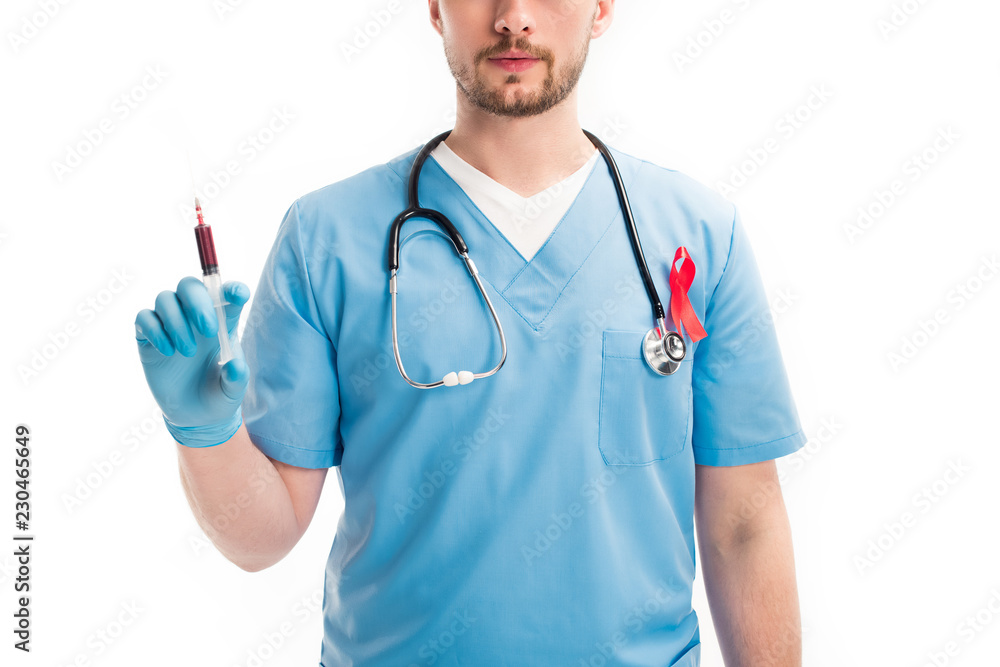 cropped image of doctor with red ribbon on uniform holding syringe with blood isolated on white, world aids day concept cropped image of doctor with red ribbon on uniform holding syringe with blood isolated on white, world aids day concept