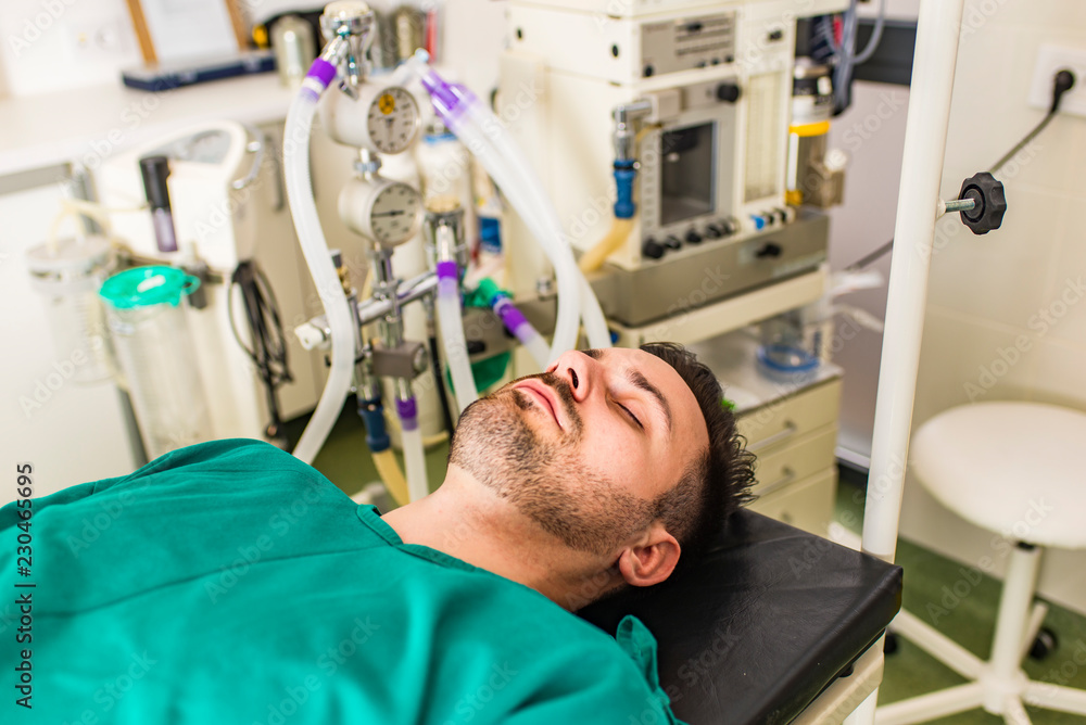 Fototapeta premium Young man lies on the operating table