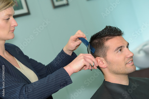 professional hairdresser making stylish haircut