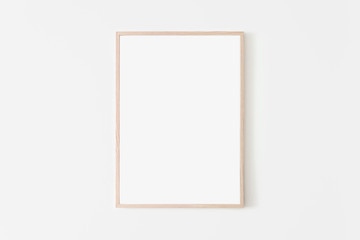 Portrait large 50x70, 20x28, a3,a4, Wooden frame mockup on white wall. Poster mockup. Clean, modern, minimal frame. Empty fra.me Indoor interior, show text or product