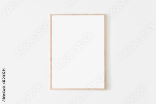 Portrait large 50x70, 20x28, a3,a4, Wooden frame mockup on white wall. Poster mockup. Clean, modern, minimal frame. Empty fra.me Indoor interior, show text or product photo