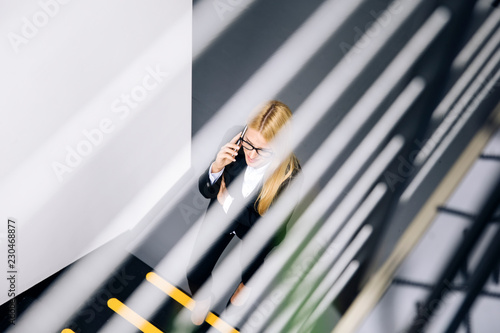 Young businesswoman using m...